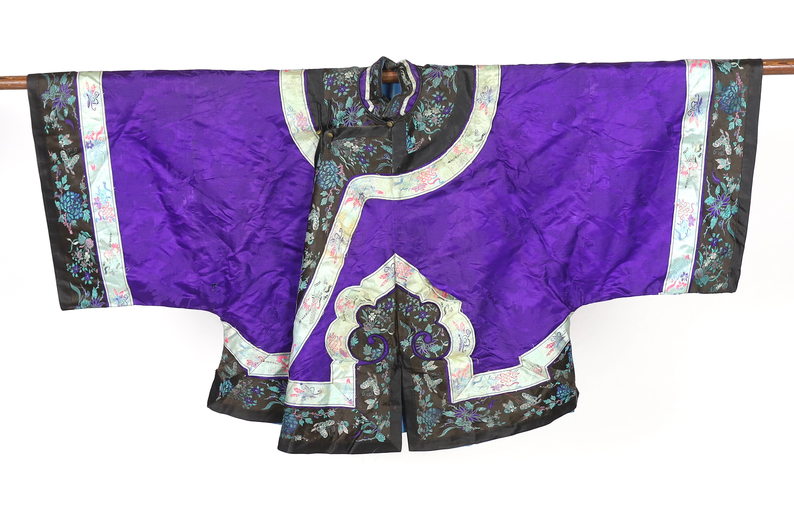 A Chinese purple damask jacket, circa late 19th / early 20th century, decorated with black and turquoise embroidered braiding with auspicious symbols, butterflies and flowers embroidery, 63cm long